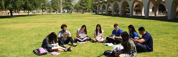 UCR students in front of Rivera Library and Bell Tower