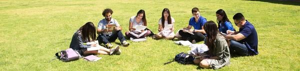 UCR students in front of Rivera Library and Bell Tower