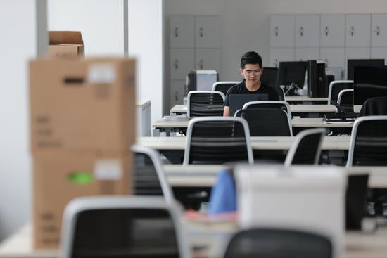 (c) UCR Stan Lim - student working on laptop in office space in MRB