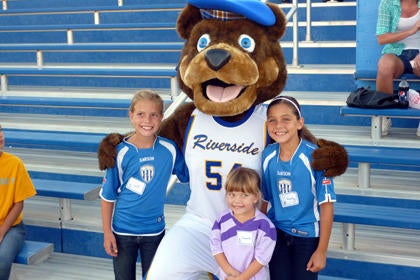 Highlander mascot with children