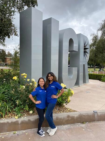 Jennalyn and Sonali in front of UCR letters